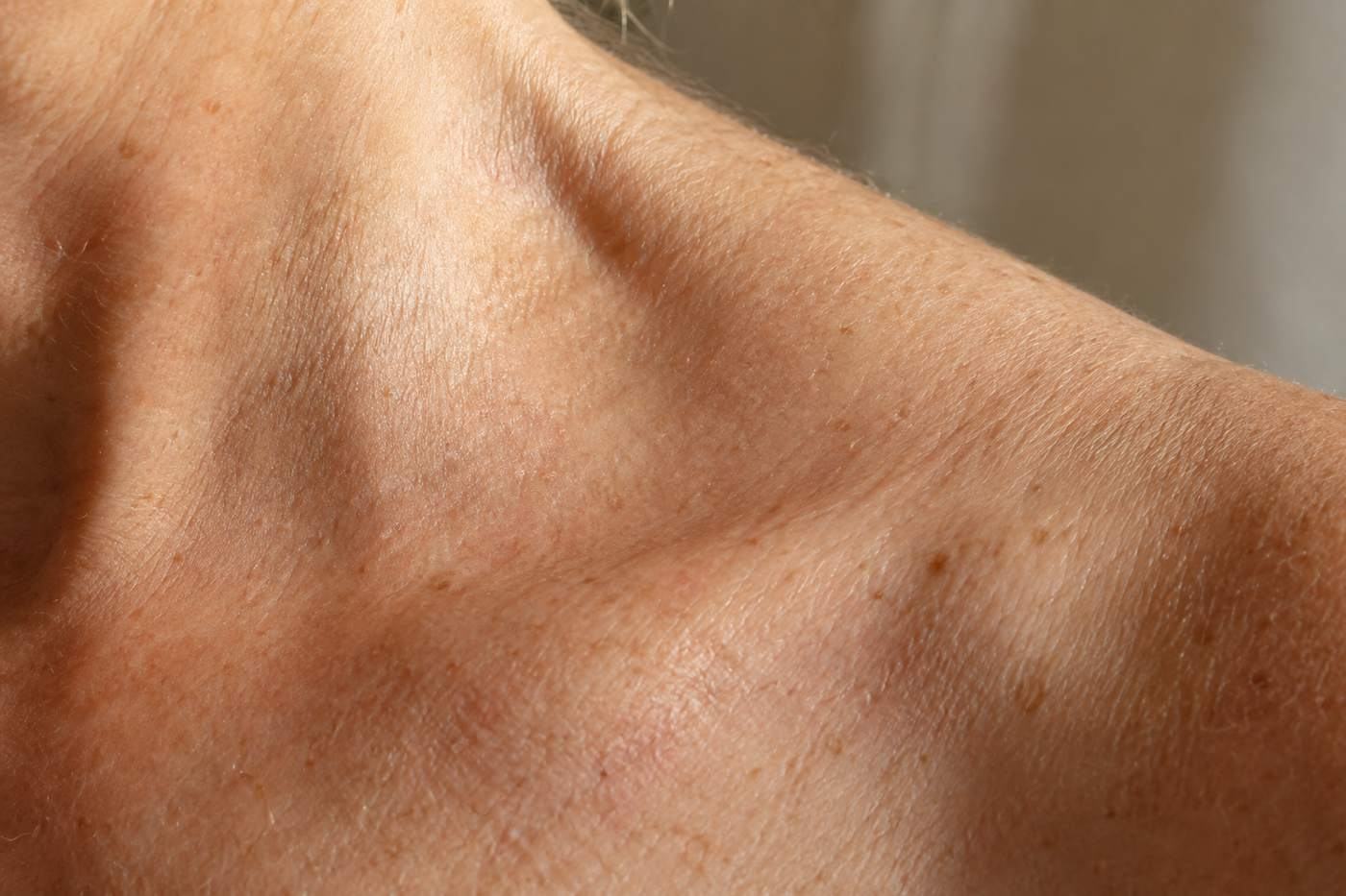 Close view of the skin across a collarbone.