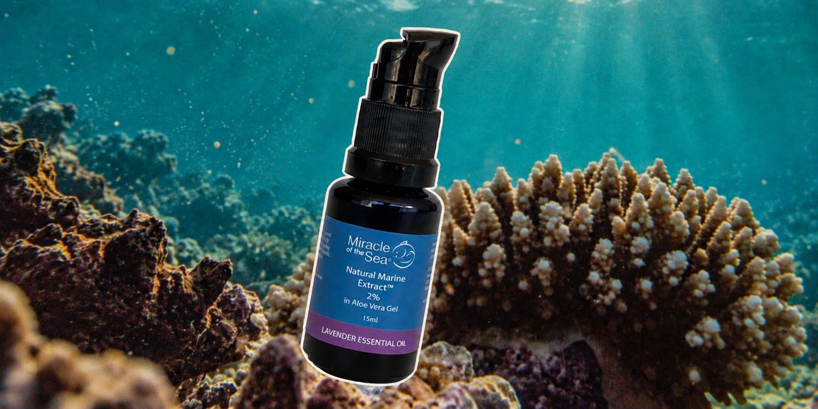 A bottle of Natural Marine Extract 2% in aloe vera gel photographed against coral.