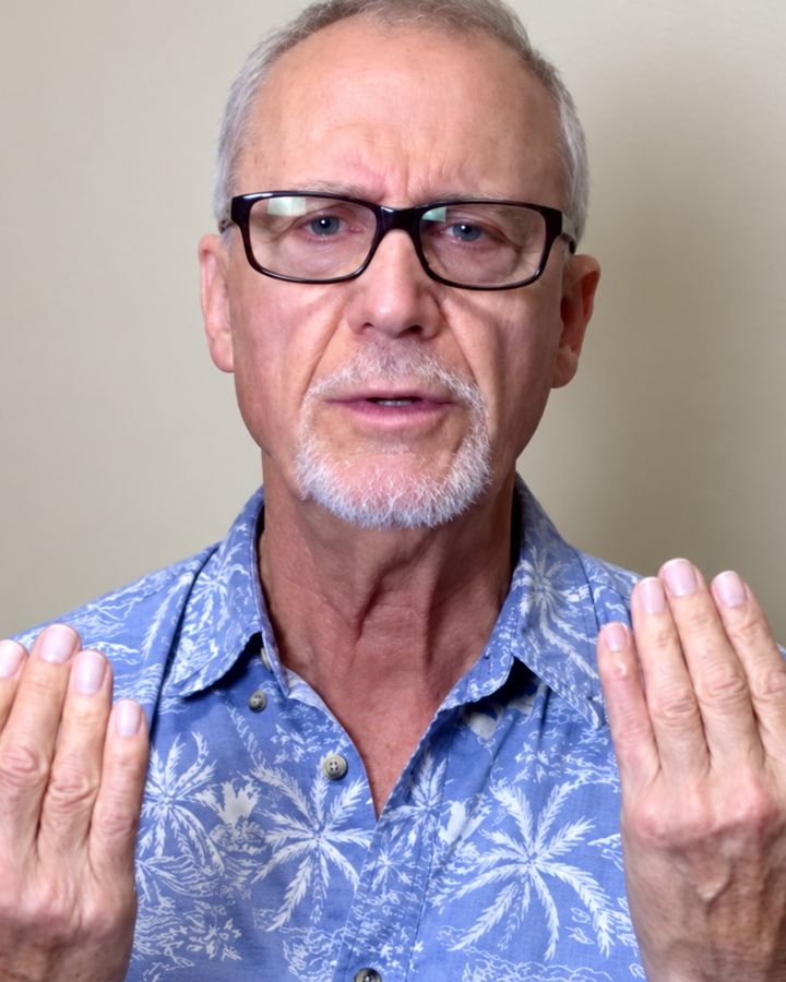 Wayne, a customer, holding up his hands in his filmed review.
